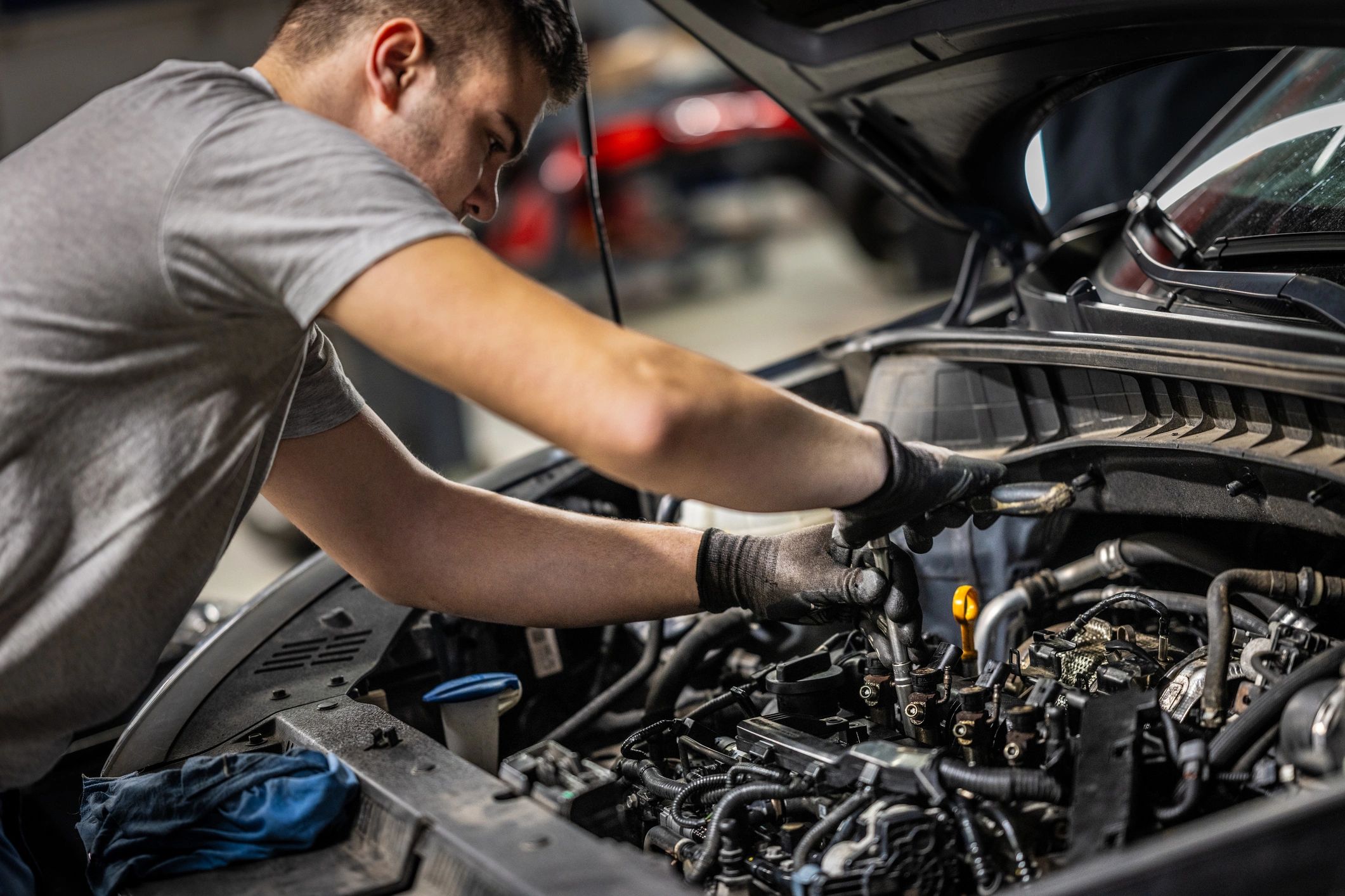 Mechanic performing engine maintenance in a clean workshop