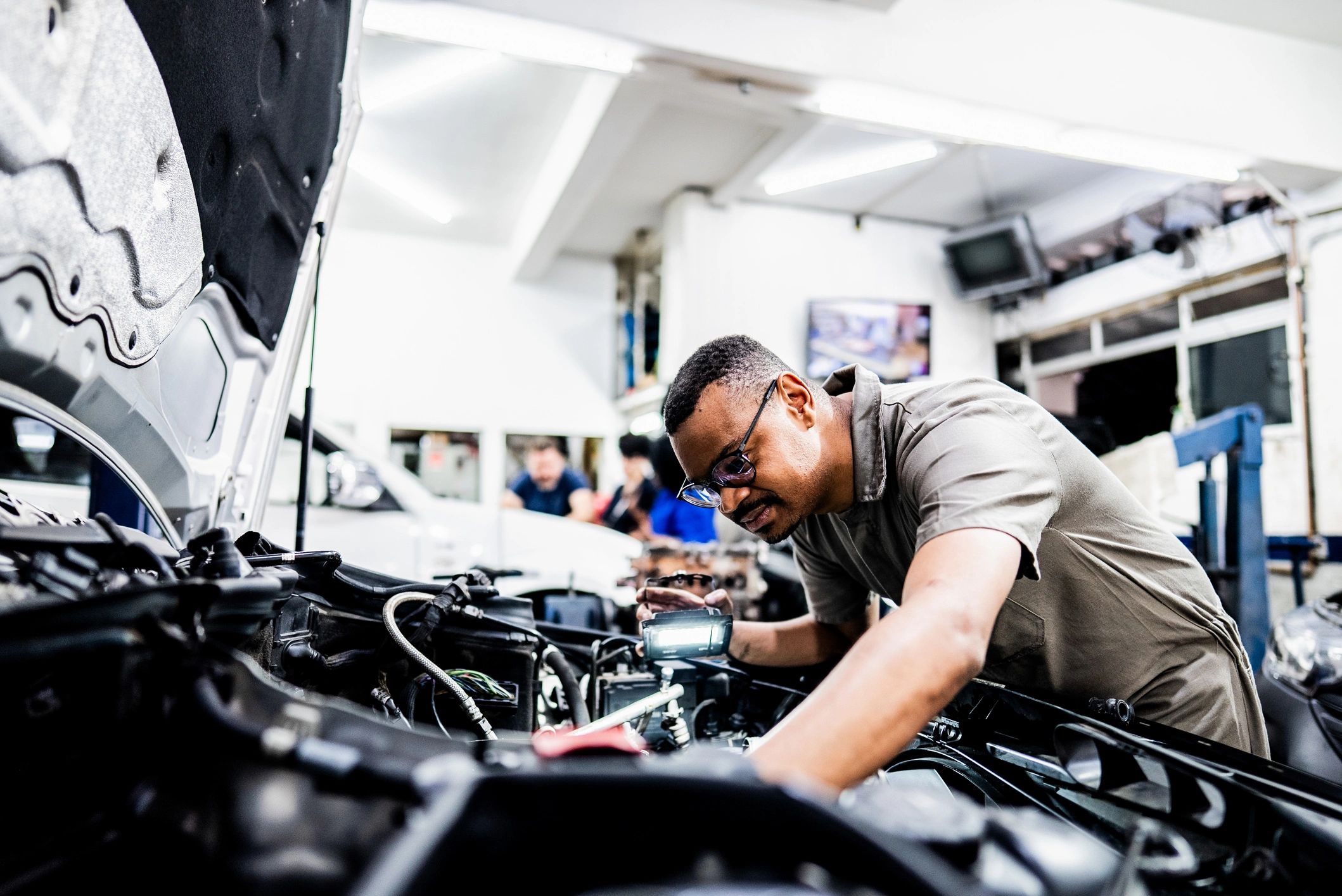 Mechanic working on a vehicle in a repair shop